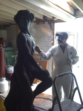 Applying a patina in the foundry on a bronze piece commissioned for a City rooftop