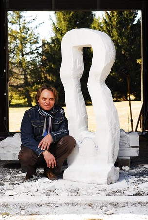 Posing for a photo journalist, Andrew stands in front of his work in progress marble in his carving studio, Fall 2007.